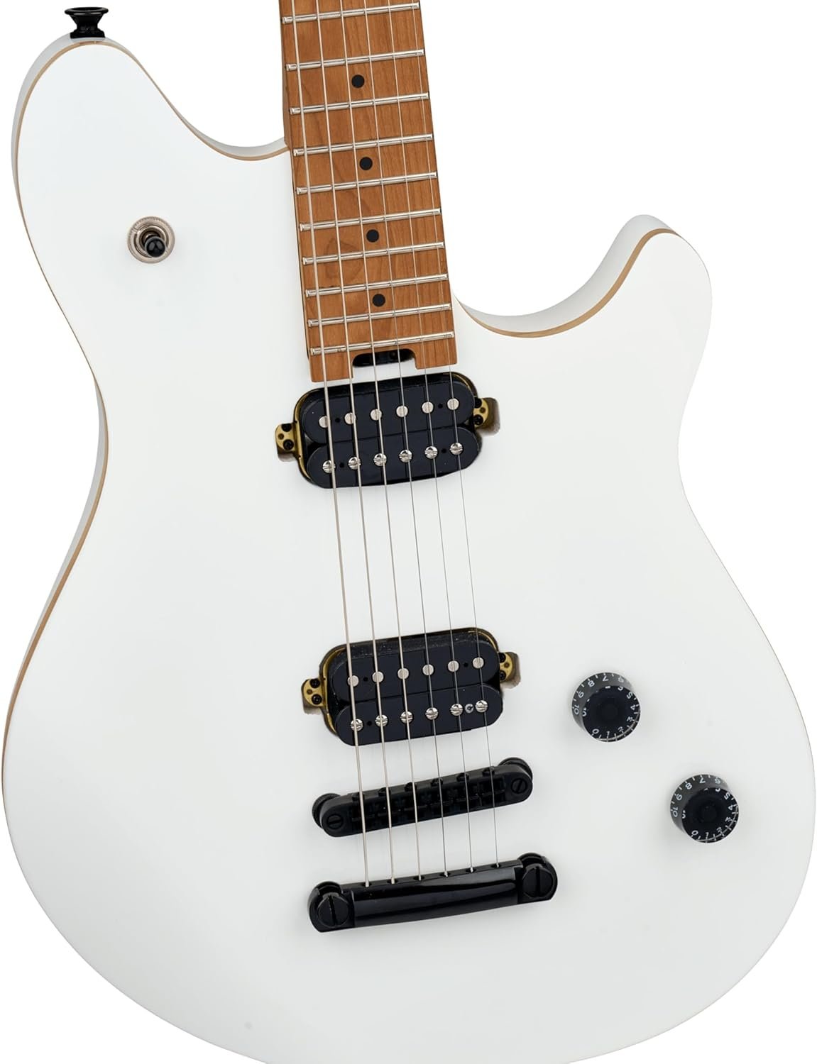 EVH Wolfgang Standard hardtail guitar in Cream White resting on a worn leather couch with a black strap attached