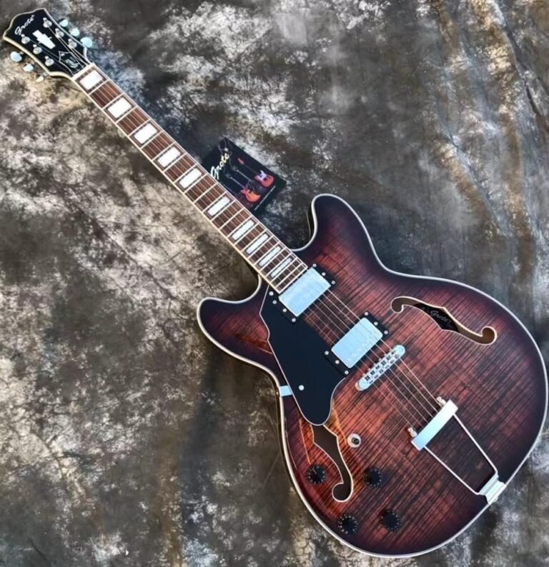 Left handed hollow body electric guitar resting in a home practice room