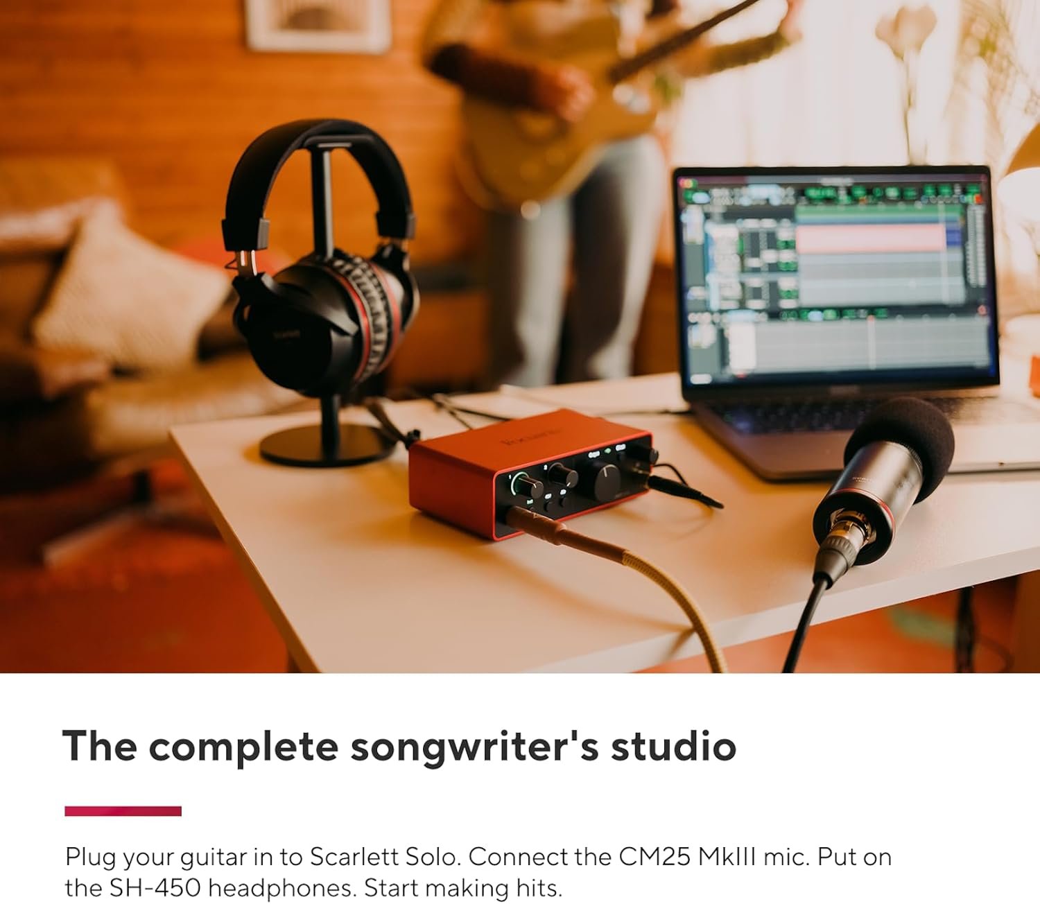 Guitarist developing original songs during a home practice session
